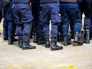 Riot police practice shields and baton