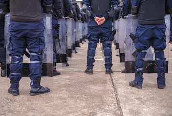 Riot police practice shields and baton