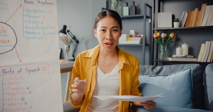 Young Asia lady english teacher video conference looking at camera talk by webcam learn teach in online chat at home. Remote classroom, Social distancing, quarantine for corona virus prevention.