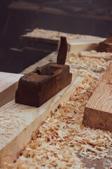 An old rusty wood planer and a piece of wood

