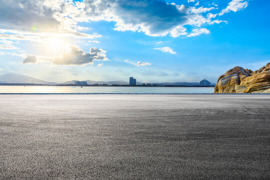 Asphalt road and beautiful seaside scenery under blue sky.