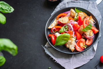 panzanella tomato salad , croutons, onion, rusk on the table healthy food meal snack vitamin copy space food background rustic. top view veggie vegan or vegetarian food