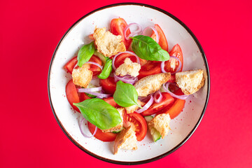 panzanella tomato salad , croutons, onion, rusk on the table healthy food meal snack vitamin copy space food background rustic. top view veggie vegan or vegetarian food