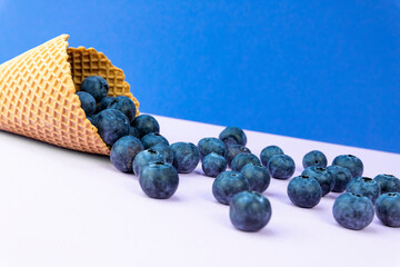 Ice cream cone with blueberries. Blueberry icecream. Healthy summer food concept