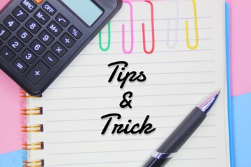 concept with Tips and Tricks with calculator, book and pen