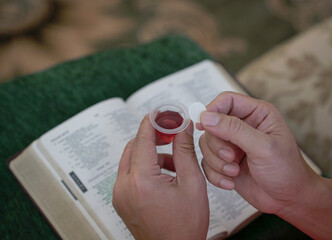 Man holding bread and wine in Hoy Communion.