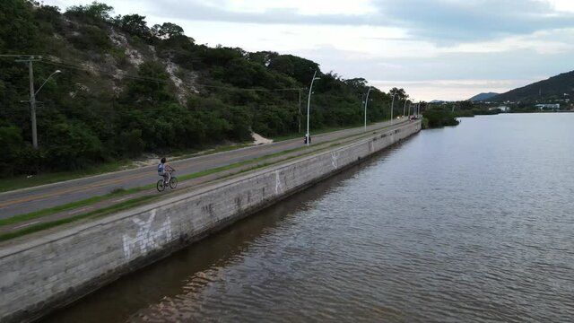 riding the bike through the Lagoa da Conceição, Florianópolis SC, Brazil