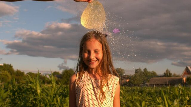 Water Balloon Splash on Little Girl's Head