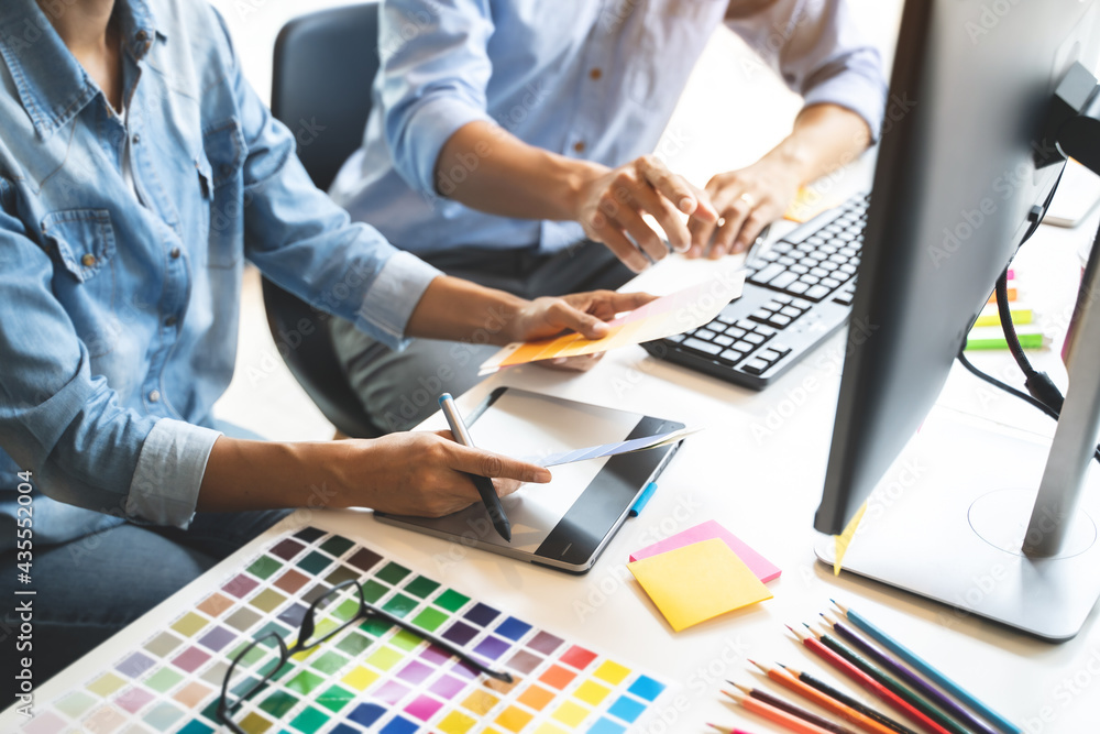 Fototapete Graphic design using graphics tablet .drawing creative logo design brand designer sketch with Color swatch samples.