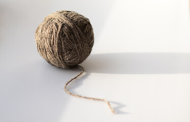 Clew of gray woolen thread on white background