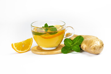 Glass cup with aromatic tea, mint leaves, lemon slice and ginger isolated on white background. Part of set.