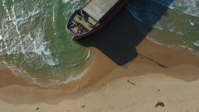 Aerial Tilt Up Shot Of Ship At Sea Shore On Sunny Day - Ashdod, Israel