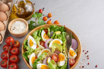 Diet menu. Healthy salad of fresh vegetables - tomatoes, egg, Onion. high angle view of a nutritious vegetable salad with boiled egg slices, served.  Healthy meal concept.