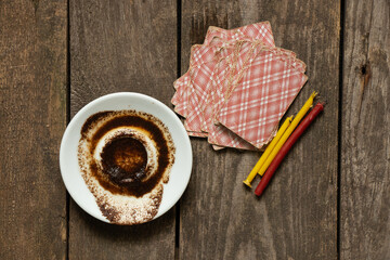 coffee grounds in a saucer and cards and candles on the table, fortune telling and prediction,...
