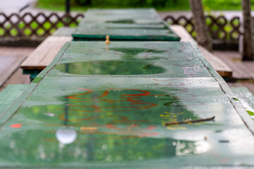 empty chess table on the street after the rain in the park