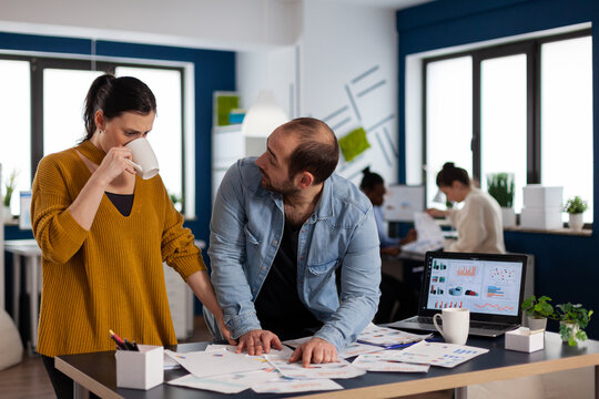 Businessman of start up consulting with advisor looking at charts statistics. Diverse team of business people analyzing company financial reports from computer. Successful start up corporate