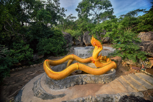 Stucco painted as a large serpent on the mountains at Wat Phu Taphao Thong temple Udon thani province Thailand. Most famous temple.