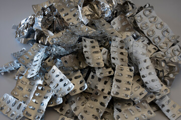 a stack of used and emptied medicine packaging. foils. Selective Focus.