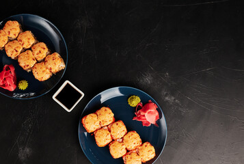 baked rolls in plates on a black textured background