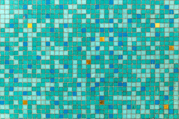 background of small squares in green color with red, blue and yellow spots