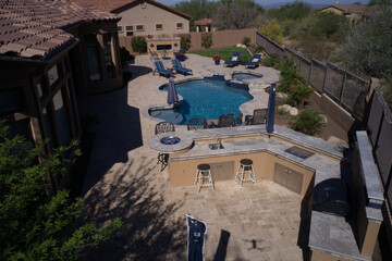 A high definition aerial view of a desert landscaped backyard in Mesa Arizona with a pool, outdoor...