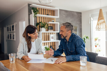 Agent and a client signing a contract.