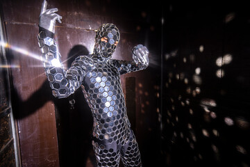 Sparkling discosuit man dancing in a lift