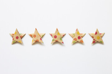 Colorful dot pattern brown five stars quality rating on white background. top view