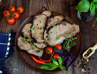 Sliced pieces of fried meat on a clay plate.