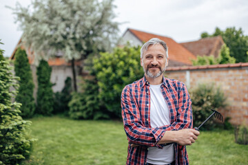 Adult man, posing for camera in the backyard,