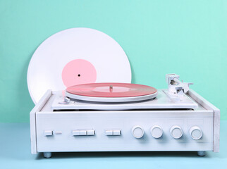 White vinyl record player on blue background. DJ equipment. Minimalism music concept. Creative...