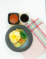 Indonesian Mie Goreng or Fried Noodle with egg traditional Indonesian or Chinese food with mustard greens
