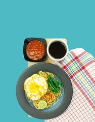 Indonesian Mie Goreng or Fried Noodle with egg traditional Indonesian or Chinese food with mustard greens