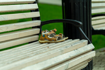 forgotten children's shoes on a park bench