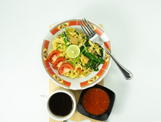 Indonesian Mie Goreng or Fried Noodle with egg traditional Indonesian or Chinese food with mustard greens
