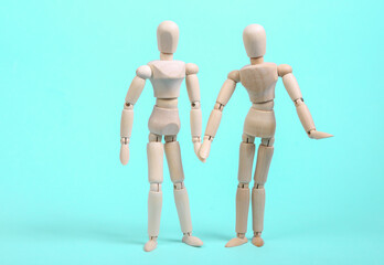 Loving couple of puppets hold hands on a blue background. Love, romantic concept