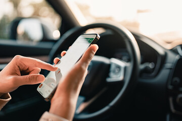 Hands of woman holding smartphone using application navigation map in a car. GPS Map to Route Destination network connection Location Street Map with GPS Icons Navigation