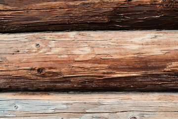 Fototapeta premium Old wooden beam with rustic house close-up
