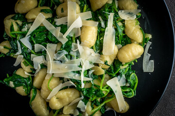 close-up gnocchi with spinach and parmesan