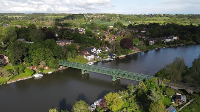 Bourne End railway and footbridge town in background sunny day  UK Buckinghamshire  Aerial footage 4K