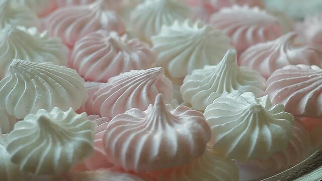 Continuous rotation of the meringue on the plate. Background, seamless loop, close-up.  Delicate white sweet dessert.