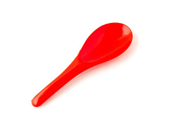 Red color of plastic spatula isolated on white background.