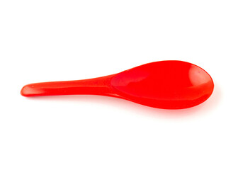 Red color of plastic spatula isolated on white background.