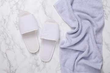 Bathroom hotel accessories. Towel and slippers on marble background