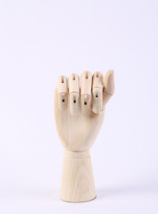 Wooden hand folded into fist on white background