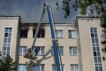 Fototapeta na wymiar firefighters extinguish a burning residential building