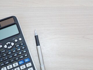 Scientific calculator pen and notepad on white background picture.