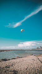 kite surfing on the beach, a man on a paraglider rides on the lake