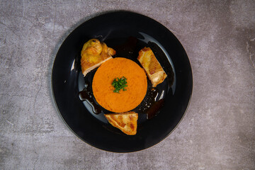 Chicken supreme recipe, gently cooked with 5 spices, sweet potato mousseline, peppers cut in half. High quality photo