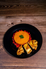 Chicken supreme recipe, gently cooked with 5 spices, sweet potato mousseline, peppers cut in half. High quality photo